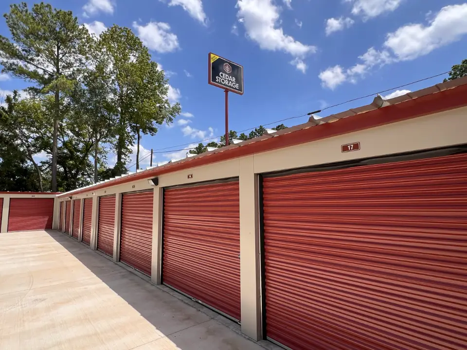 Drive-up storage units with red roll-up doors in Willis, TX
